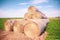 Landscape of a large hay field with numerous straw bales