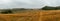 landscape, late gloomy autumn, agricultural field after harvest with dry grass and straw, cloudy weather with a stormy