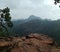 Landscape of layers of mountains and rocks in front.