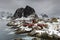 Landscape of the Lofoten Islands in Norway with traditional wooden red fisherman huts in front of the sea and this beautiful mouta