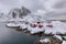 Landscape of the Lofoten Islands in Norway with traditional wooden red fisherman huts in front of the sea and this beautiful mouta