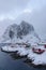 Landscape of the Lofoten Islands in Norway with traditional wooden red fisherman huts in front of the sea and this beautiful mouta