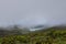 Landscape of low clouds and bad weather over Lagoa Funda das Lajes caldera volcanic crater lake at Ilha das Flores island in the