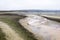 The landscape is lowered reservoir contains water and markers in the form of poles of wood. Direction of the artificial lake