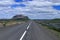 Landscape with Lupines Blooming along Empty Road of Route 26 with Burfell Volcano in Western Iceland