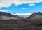 Landscape of Maelifellsandur volcanic black sand desert with Myrdalsjokull glacier and blue sky, summer in Highlands of Iceland