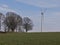 Landscape with meadow, wind turbine for electric power generation