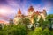 Landscape with medieval Bran castle known for the myth of Dracula at sunset