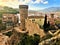 Landscape, medieval tower and wall, sky, trees, roofs in Tossa de Mar, Spain