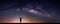 Landscape with Milky way galaxy. Night sky with stars and silhouette happy man on the mountain. Long exposure photograph.