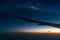 Landscape with Milky way galaxy. Night sky with sunrise and silhouette wing of an airplane.