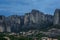 Landscape of monasteries of Meteora in Greece in Thessaly at the early morning. Cliffs of Meteora opposite a morning cloudy sky ba