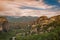 Landscape of monasteries of Meteora in Greece in Thessaly at the early morning. Cliffs of Meteora opposite a morning cloudy sky ba