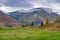 Landscape of a mountain autumn rocky valley with clouds, mists