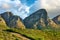 Landscape of a mountain in Cape Town, South Africa in the day. Rocky mountaintop with greenery against cloudy sky. Below