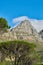 A landscape of a mountain with a cloudy blue sky background and copy space. Peaceful and scenic view of a summit near