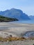 Landscape of the mountain covering by tree on the seacoast under the clear blue sky