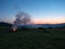 Landscape of mountain pasture, bonfire and evening sky. Carpathians mountains at summer, west Ukraine. Nature background