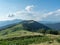 Landscape of mountain pasture. Carpathians mountains, west Ukraine. Blue sky with big white clouds. Nature background