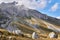 Landscape with a mountain peak in the clouds and white boulders in the foreground