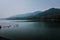 Landscape with mountain range and with calm seascape in the foreground in West Lake.