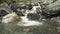 Landscape mountain stream waterfall flowing over rocks