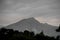 Landscape of mountain Tahtali in the fluffy clouds in the foreground of branches