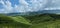 landscape of mountains and alpine meadows as well as clouds