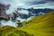 landscape with mountains, hills, clouds, grass and fog