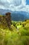 landscape with mountains, hills, clouds, grass and rocks