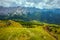 landscape with mountains, hills, clouds, grass and trees