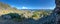 landscape of the mountains in the morning in Norway with a view on ocean at horizon under blue sky