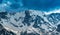 Landscape with the mountains in snow and heavy clouds in the background