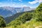 Landscape with mountains, valley, forest, meadows high on the top