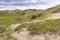 Landscape Nationaal Park Hollandse Duinen with dunes under a clouded sky