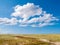 Landscape of national park Schiermonnikoog with cumulus clouds,