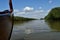 Landscape on a navigable canal surrounded by vegetation in the Danube Delta during a beautiful sunny day with blue sky. Cruising