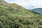 The landscape near famous Glenfinnan Viaduct in Scotland with a historic steam train and red waggons in the background in nice