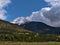 Landscape near McBride, Canada viewed from Yellowhead Highway with meadow, colorful forest on the slope and peak.