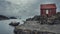 Landscape in Norway. solitude with nature. Traditional lonely Red wooden hut on the rocky shore of the northern sea and boat