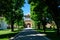 Landscape with old green trees and grey alley in Mogosoaia Park Parcul Mogosoaia, a weekend attraction close to  Bucharest,