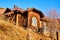 Landscape with old wooden house near lake with blue water and sky. Lake Baikal. A tourist sightseeing train moves along the Circum