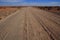 Landscape with open dusty dirt road