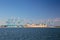 Landscape orientation of Freighter ship and cranes at loading dock