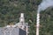 Landscape overlooking the chimney of a small sugar mill, mountain background