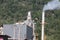 Landscape overlooking the chimney of a small sugar mill, mountain background