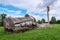 Landscape with overturned old water tower, wooden barrel on the ground, fragments of white brick ruins, Latvia, Vaidava