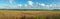 Landscape panorama, in the background wind farms, fields, forest, grain