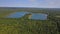 Landscape panorama, blue water in a forest lake with trees sky panorama