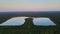 Landscape panorama, blue water in a forest lake with trees twilight sunset sky panorama